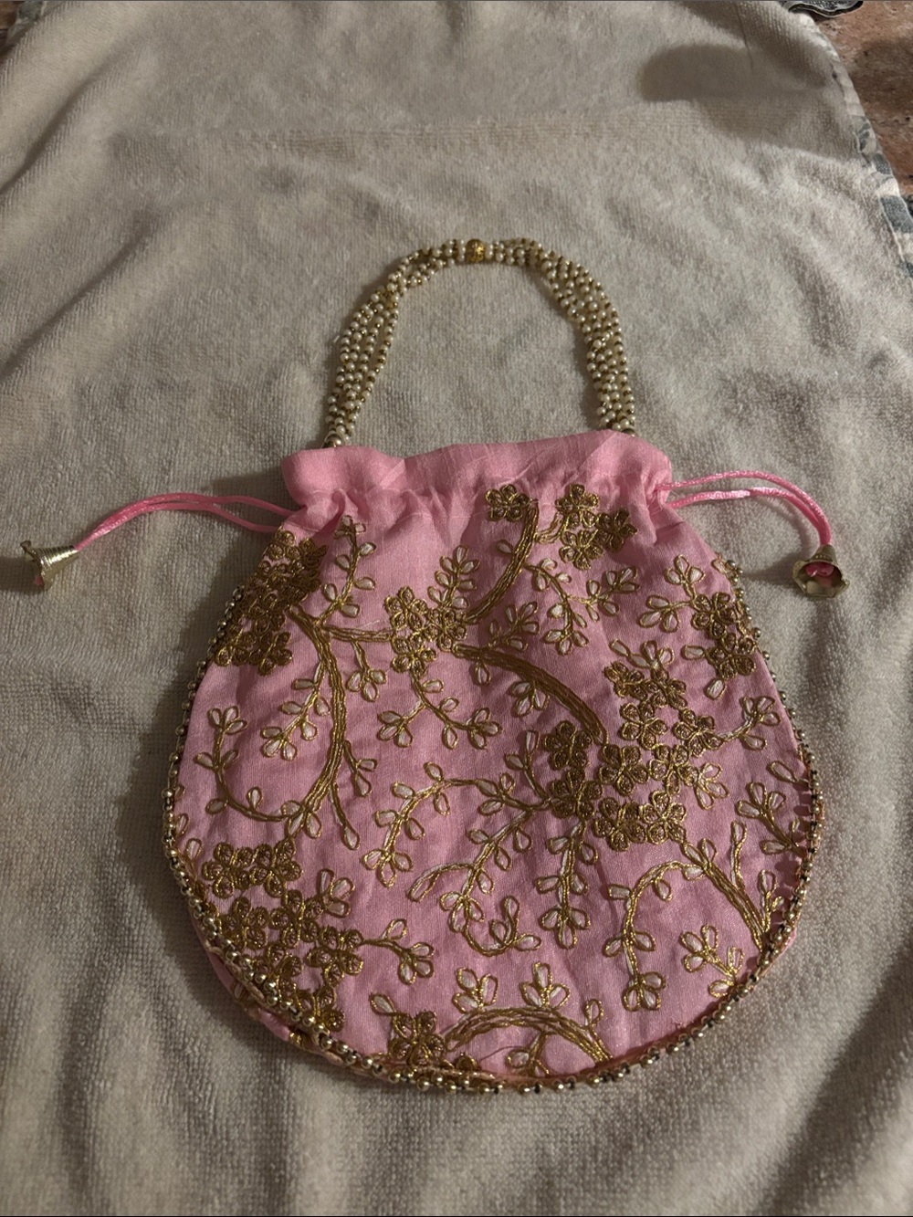 Pink Potli bag with gold floral embroidery and beaded pearl handle